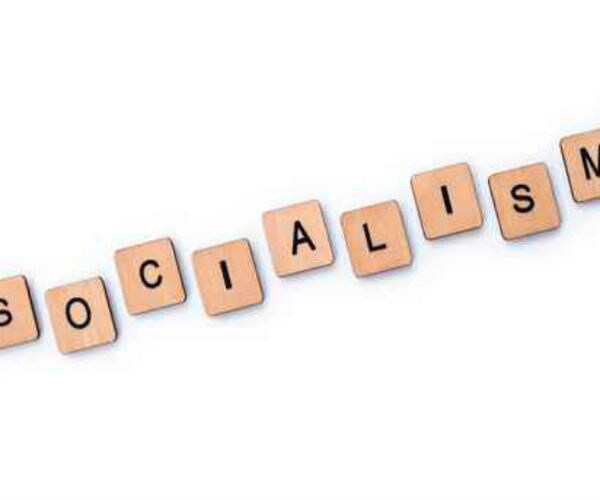 'socialism' spelled out in scrabble word tiles