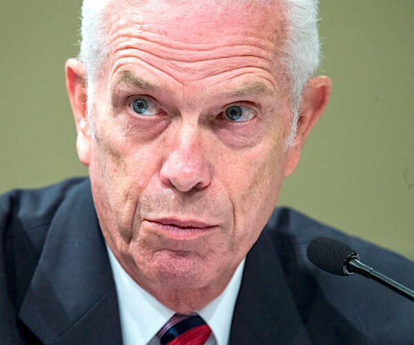 ohio republican representative bill johnson leans forward to speak into the mic during a house hearing