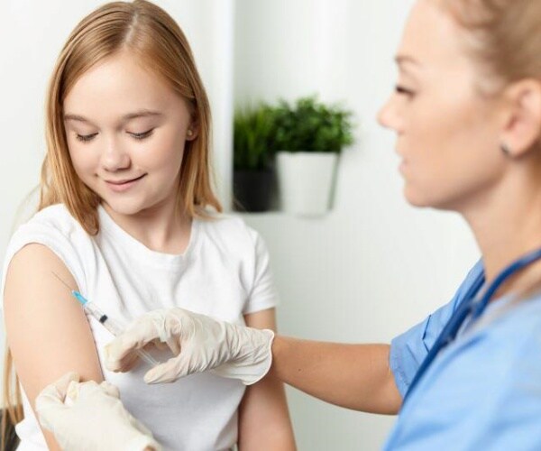 Young girl receiving COVID vaccine