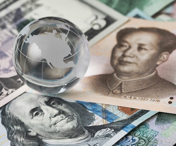 decoraton glass globe on US dollar and china yuan banknotes.