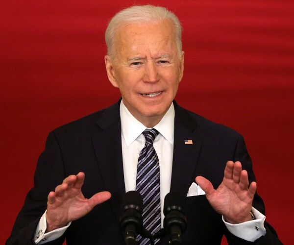joe biden speaks into microphone