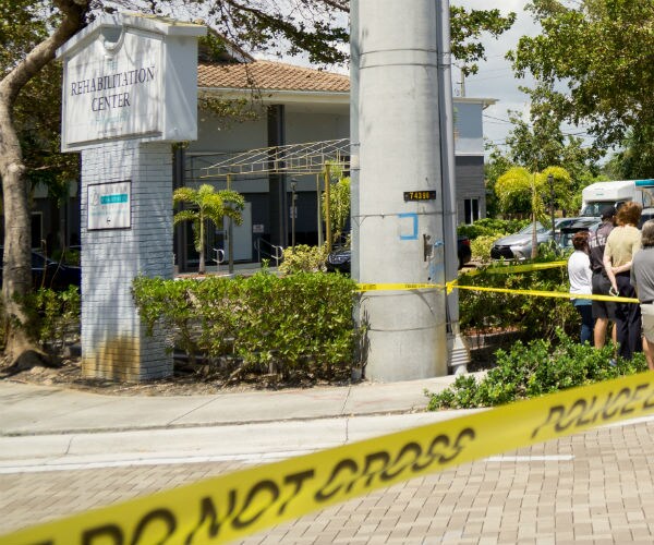 the sign for the nursing home with crime scene tape outside