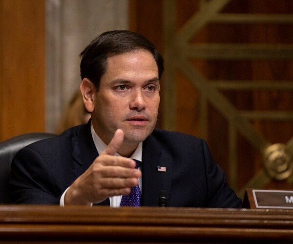 rubio in a suit and blue tie speaking at a hearing