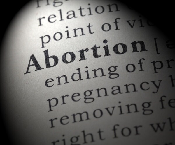 dictionary definition of the word abortion including key descriptive words