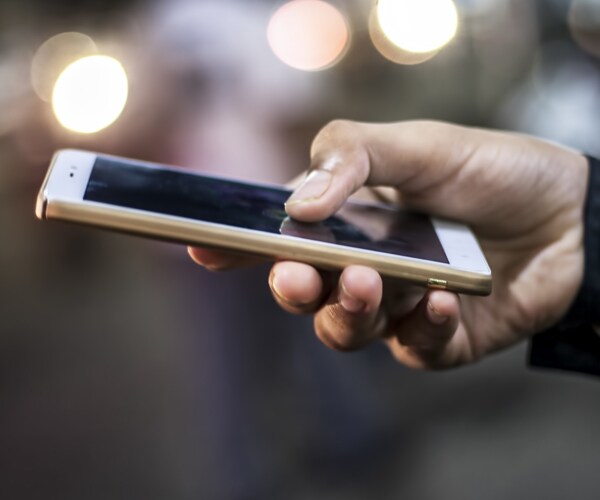 a hand holding a cell phone