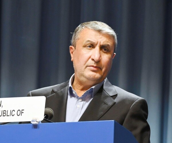 mohammad eslami speaks into a microphone
