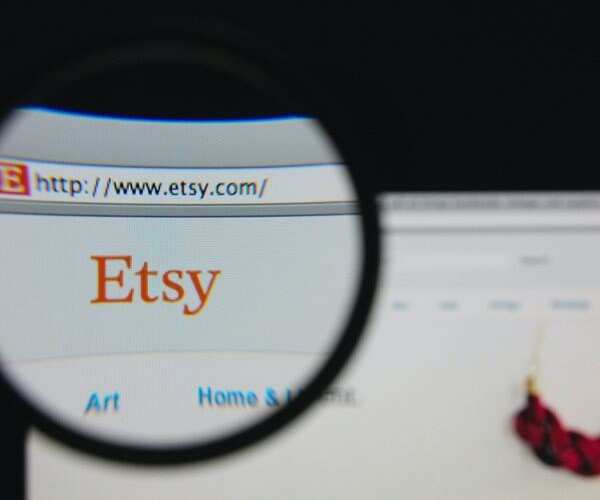 image of etsy homepage with etsy logo viewed through magnifying glass