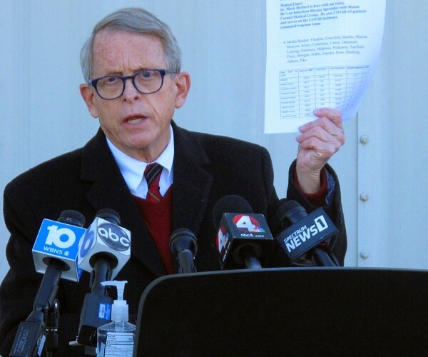 mike dewine speaks into microphone