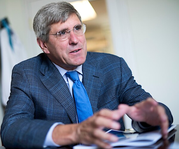 economist stephen moore sits and gestures while he conducts a media interview