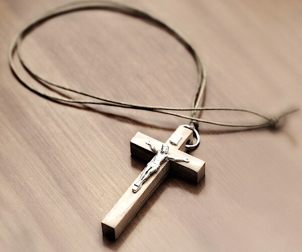 a cross lays on a table