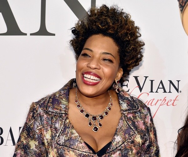 macy gray stands on red carpet