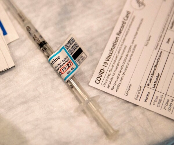 a syringe and vaccination card