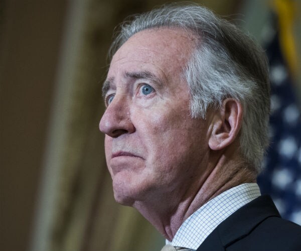 richard neal is seen in the capitol during a bill enrollment with the us flag in the background