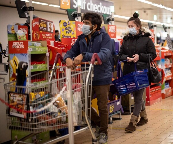 people queue with their shopping carts