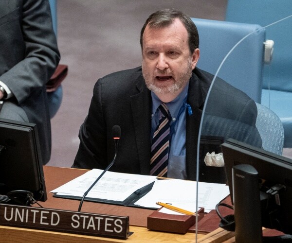 richard mills speaks into a micorphone