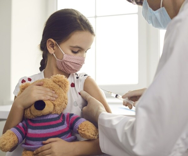 young girl getting covid vaccine