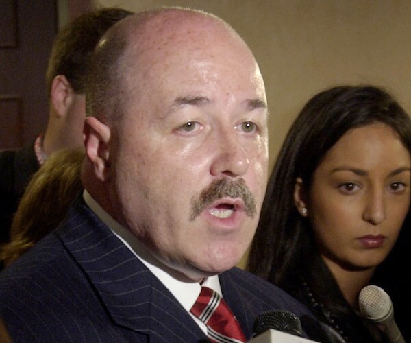 bernie kerik gives a media briefing with reporters looking on