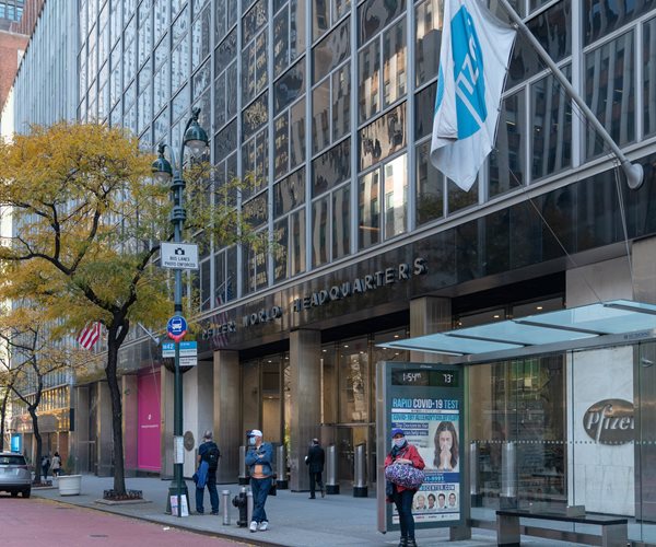 people walk by pfizer headquarters