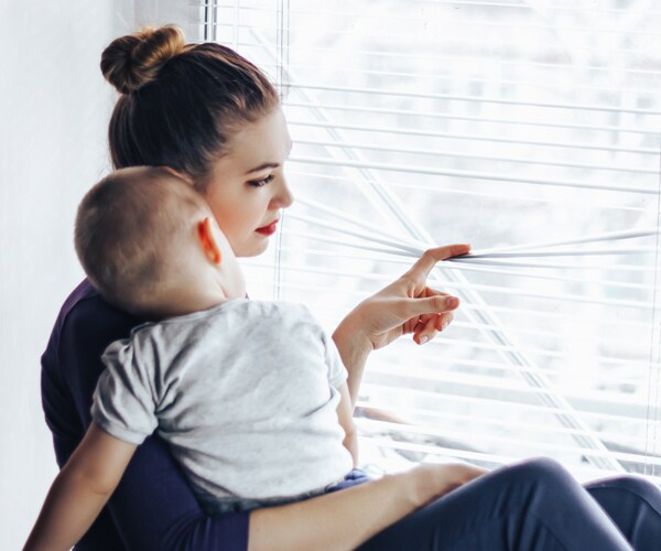 a teenage mother holding her baby