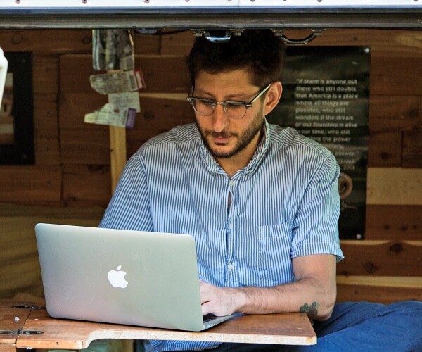 danny fenster works on laptop