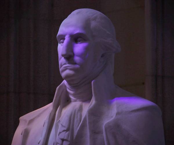 a bust of george washington against a dark background
