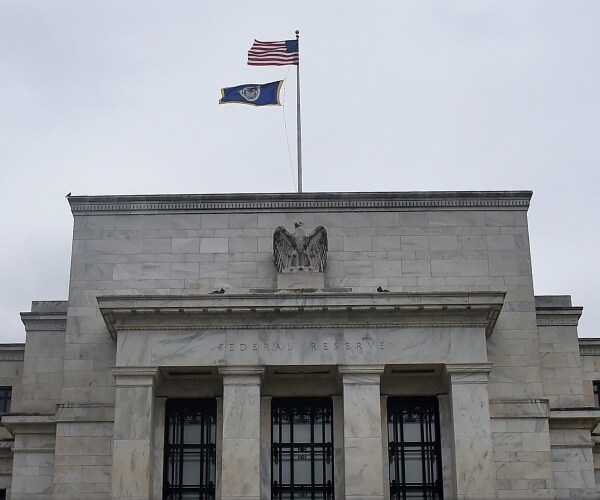 federal reserve is shown with a us flag flying on top