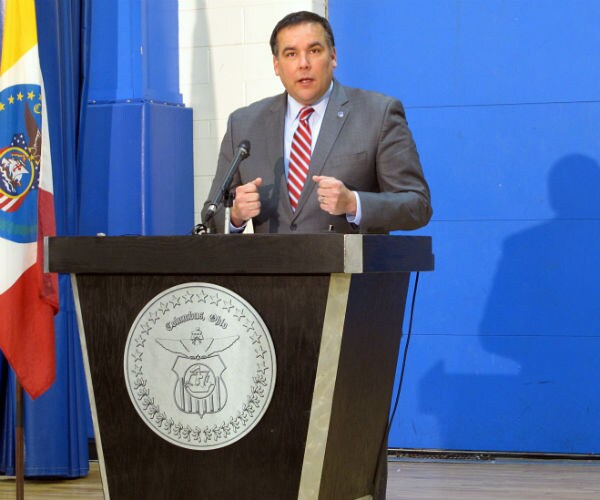 columbus mayor andrew ginther is shown speaking at a podium