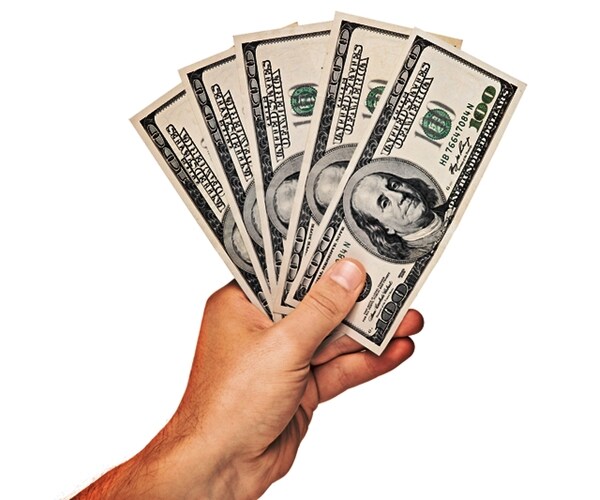 hand holding us dollars isolated on white background

