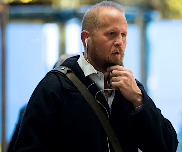 brad parscale grabs his beard while walking through an airport