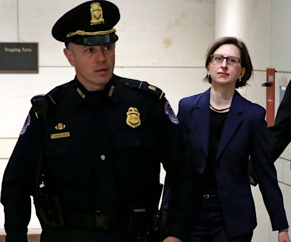 laura cooper walks out of the court room behind a security detail