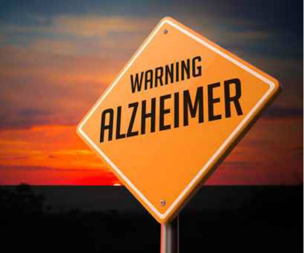 graphic shows words alzheimer's warning on a sign with an orange sunset background