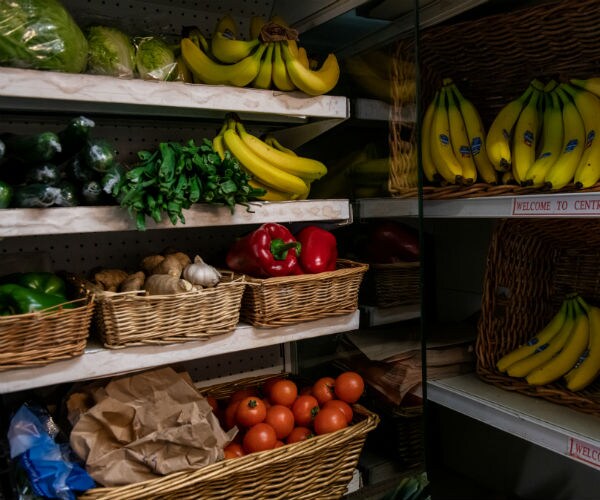 fruits and vegetables are shown in baskets on shelves