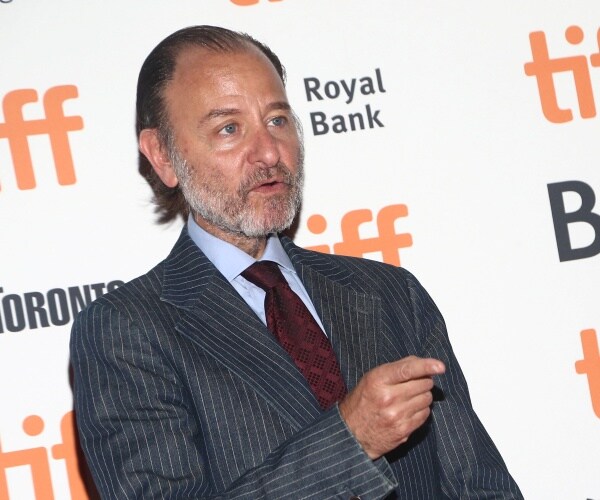 stevens in a striped suit and burgundy tie