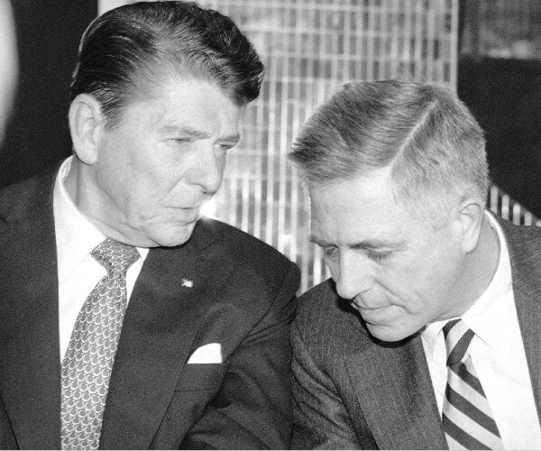 reagan and buckley talk while seated at a table