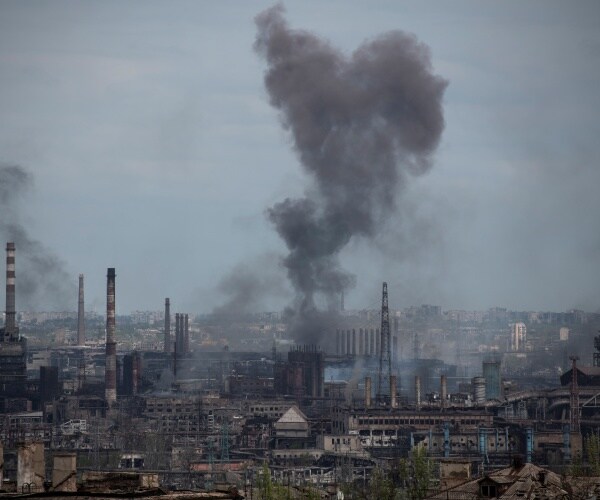 smoke rises from a building
