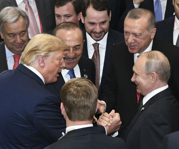 president donald trump shakes hands with russian president vladimir putin