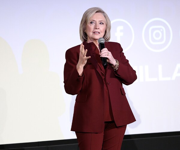 hillary clinton standing on a stage and talking