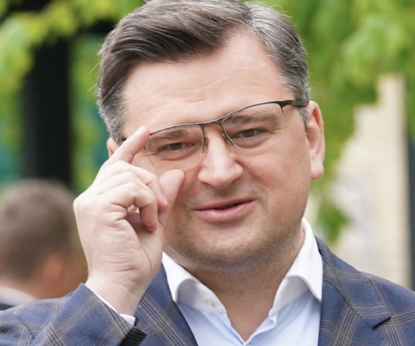 ukrainian foreign minister dmytro kuleba adjusts his glasses