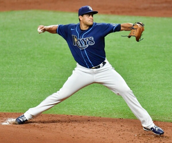 player wearing rays uniform pitches 
