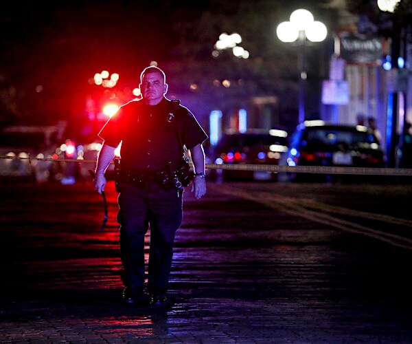 a police officer secures the crime scene in dayton, ohio after a mass murder