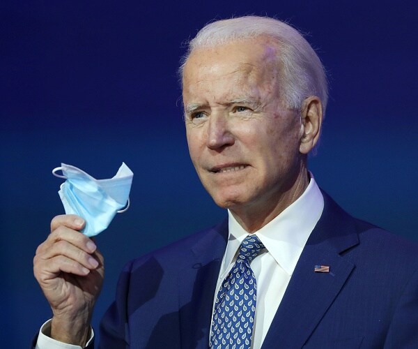 joe biden holds up mask
