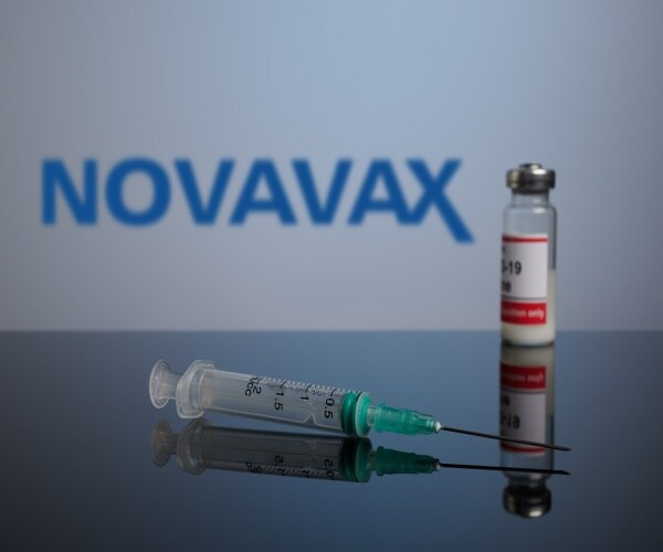 A photo of new Novavax vaccine and syringe