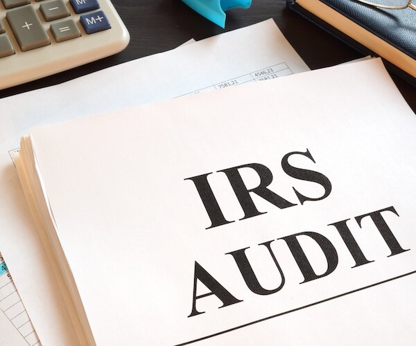 papers on a desk labeled irs audit