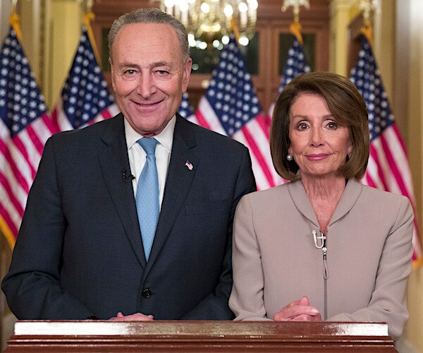 Senate Minority Leader Chuck Schumer and House Speaker Nancy Pelosi stand and await their response