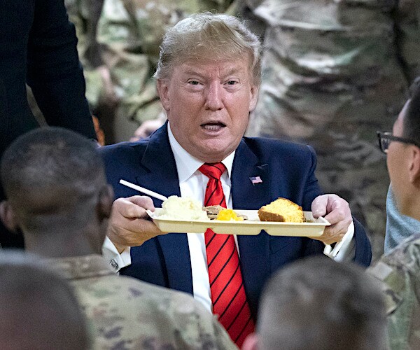 President Donald Trump hands out Thanksgiving dinner to troops overseas in 2019