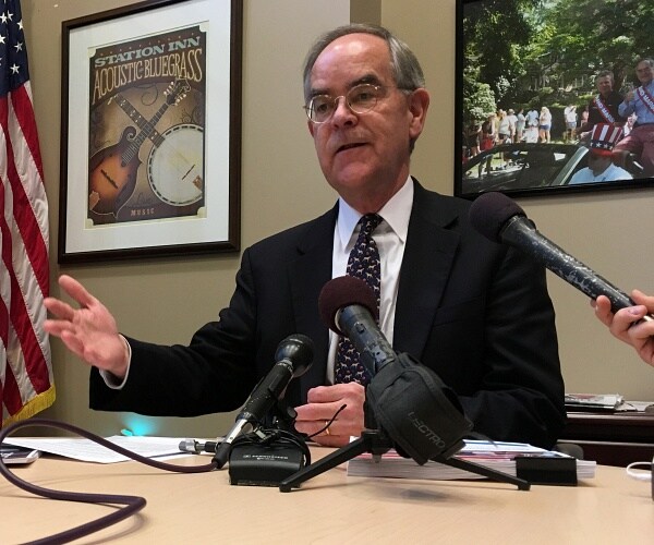 jim cooper talks to press in his office