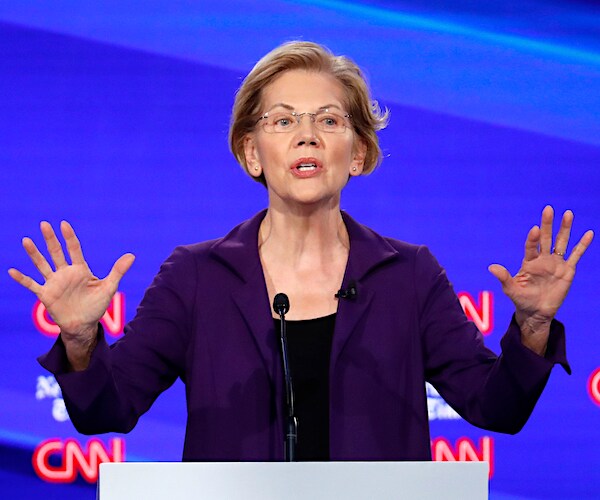 elizabeth warren throws up both hands during the democratic presidential primary debate