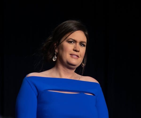 sarah sanders, wearing a blue gown, is dressed up for a media event