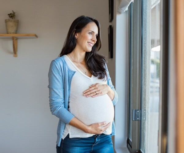 pregnant woman looking out window