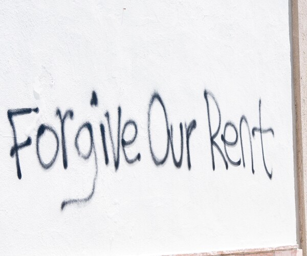 a forgive our rent message on a building wall in los angeles